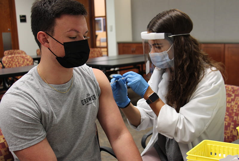 Student participate in vaccination clinic held on campus.